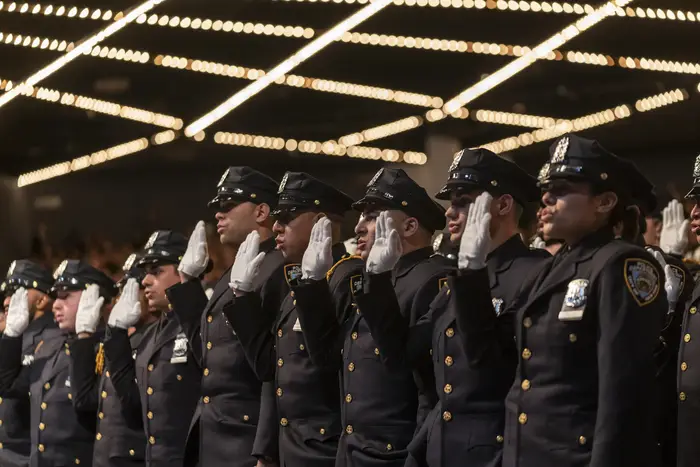 Uniformed officers saluting.